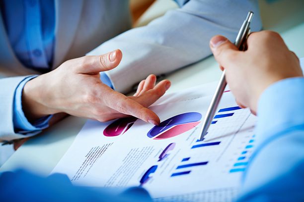 Hands pointing to a business document 