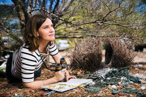 Student in front of bowerbird nest. 