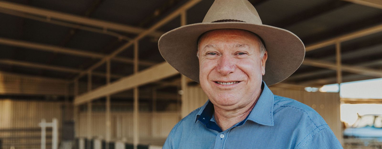David Phelps wearing a hat and standing in a large shed