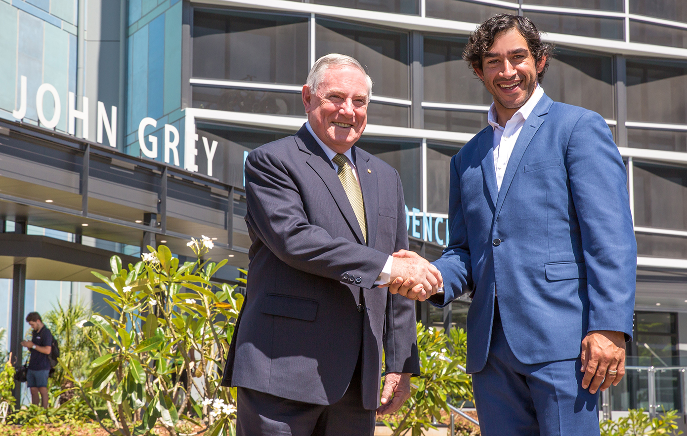 John Grey and Johnathan Thurston shaking hands in front of John Grey Hall