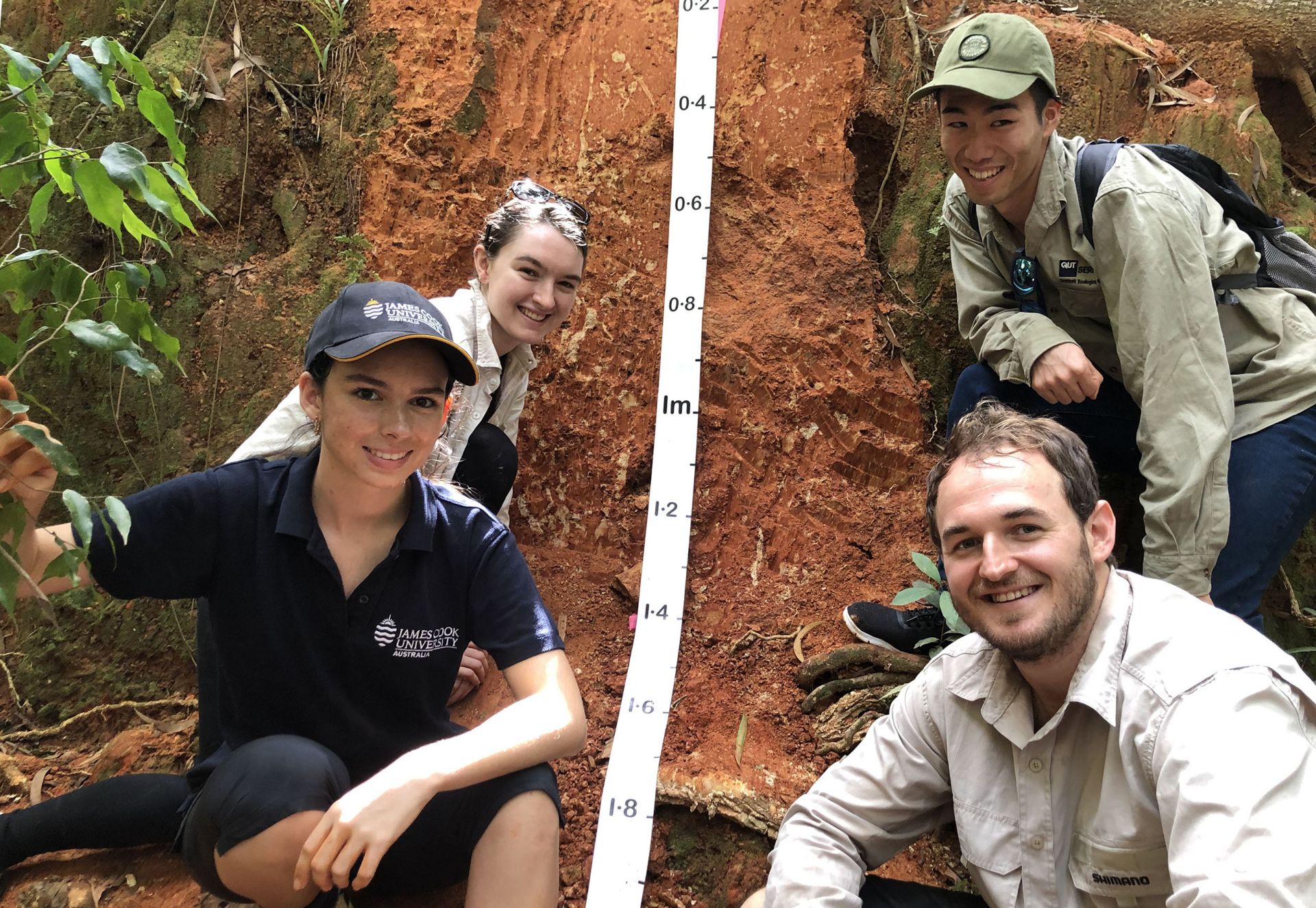 students in front of an earth bank
