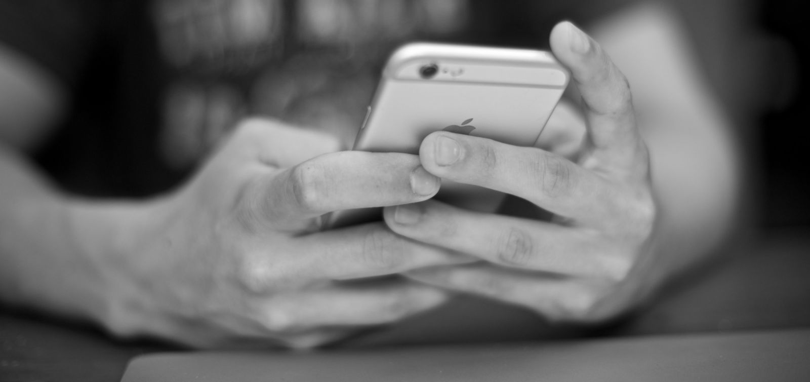 teenager's hands holding a mobile phone