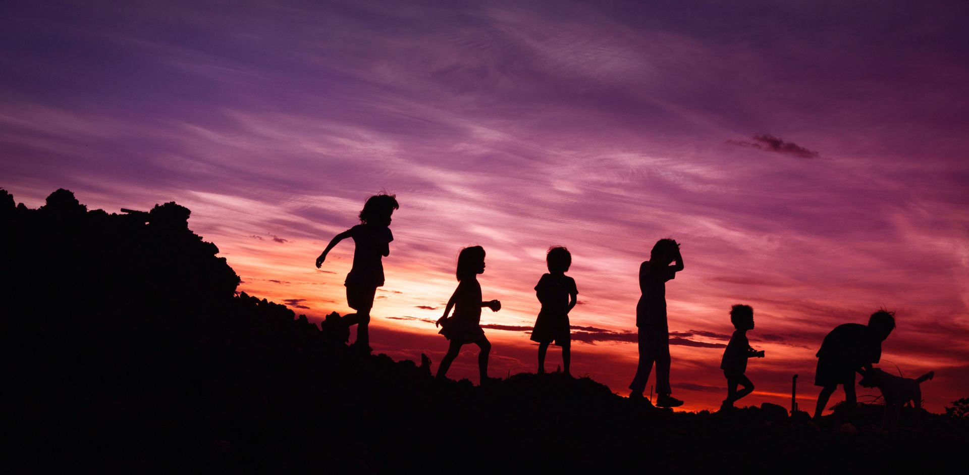 Children playing at sunset