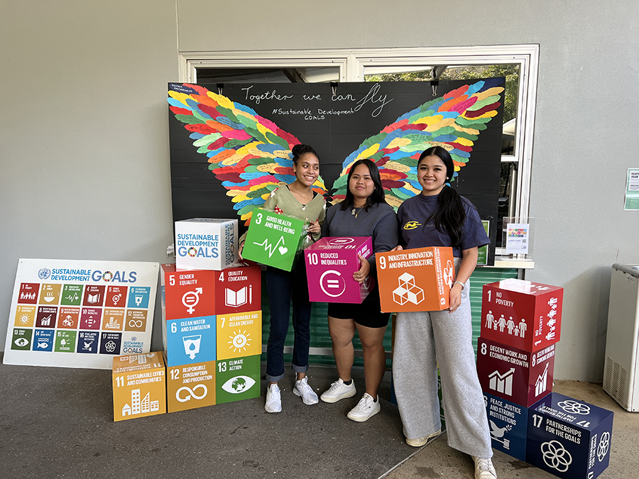 Students holding sustainability boxes. 