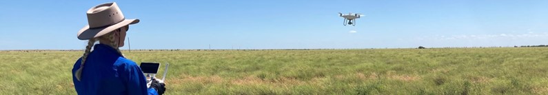 Lucy Gardner in field with drone. 