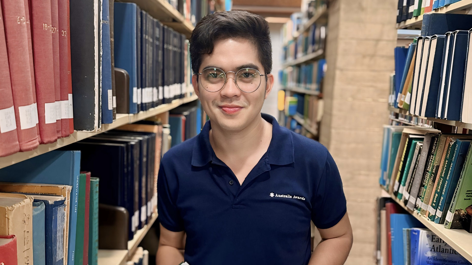 JCU Master of Science international student Christian Gino on campus at a library on the Townsville Bebegu Yumba campus. 