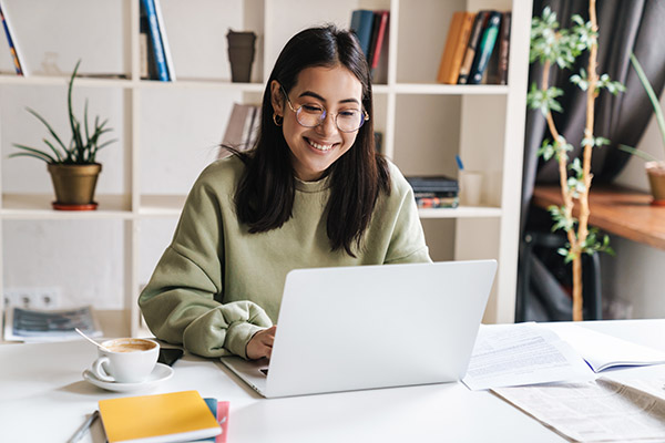 A female student studies at a laptop. 