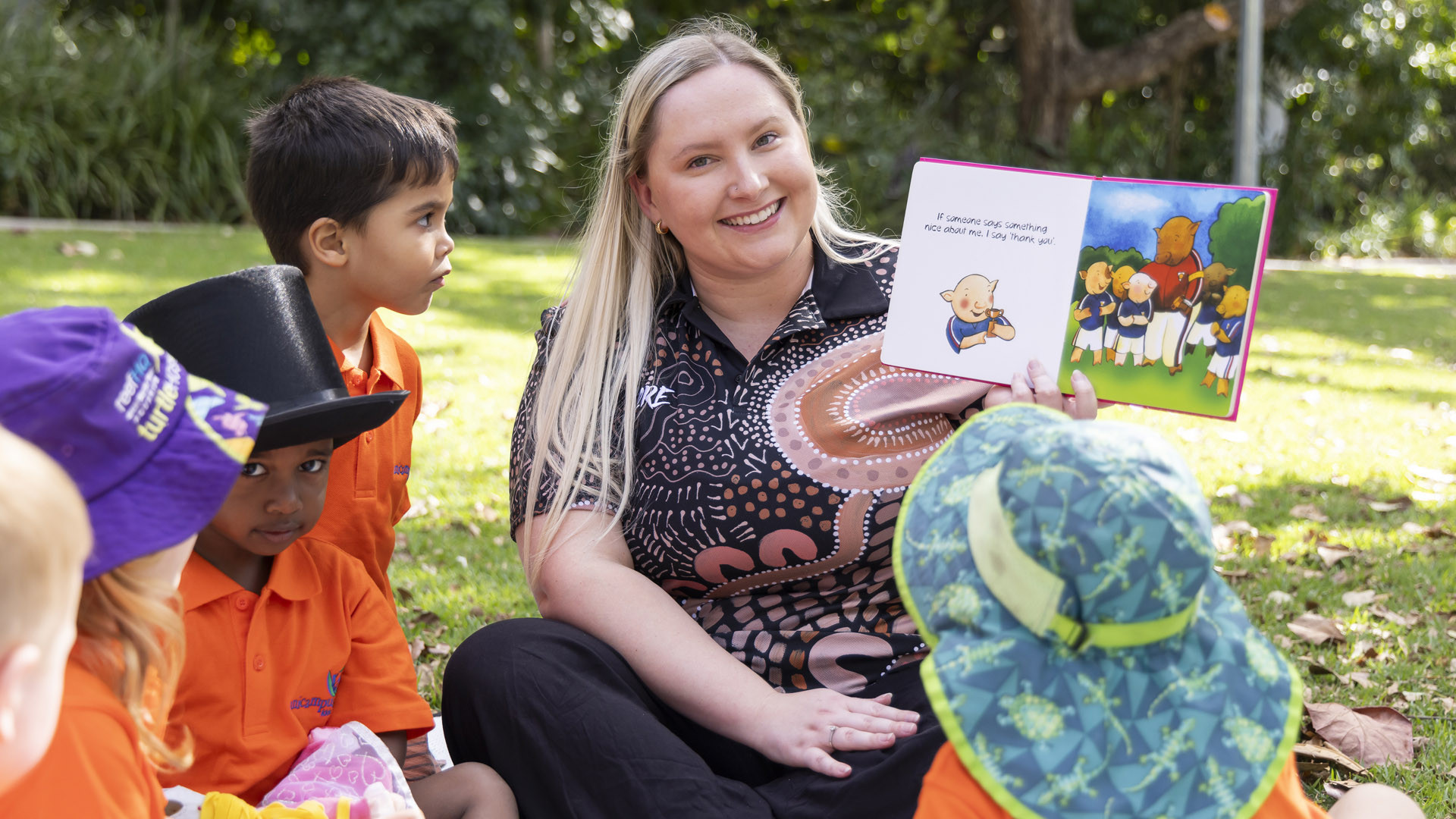 A JCU Bachelor of Education (Early Childhood Education) student reads a story to a group of children. 