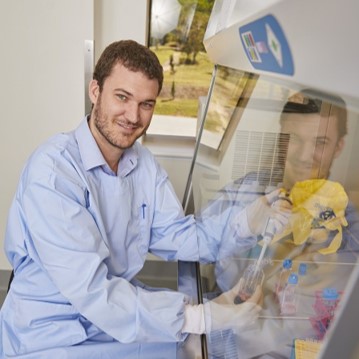 man using a fume hood in a lab