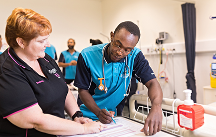 nursing students looking at paperwork. 