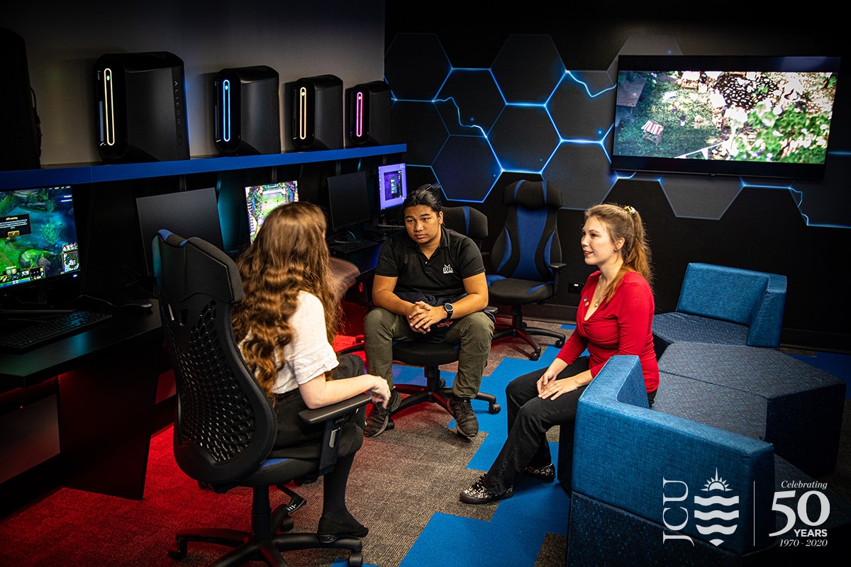 3 students chatting in the JCU eSports room