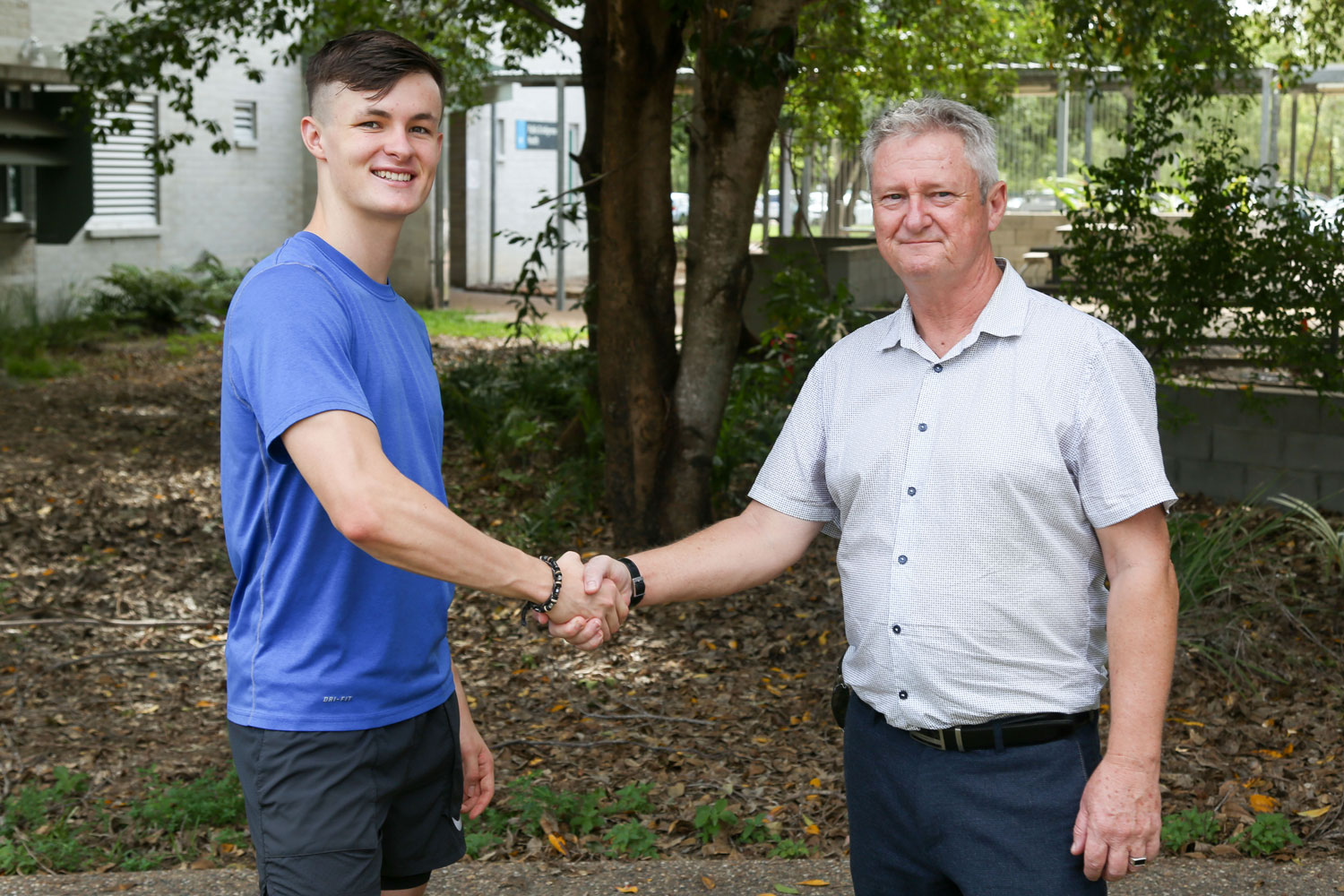 Jake Doran shakes hands with Prof Chris Cocklin