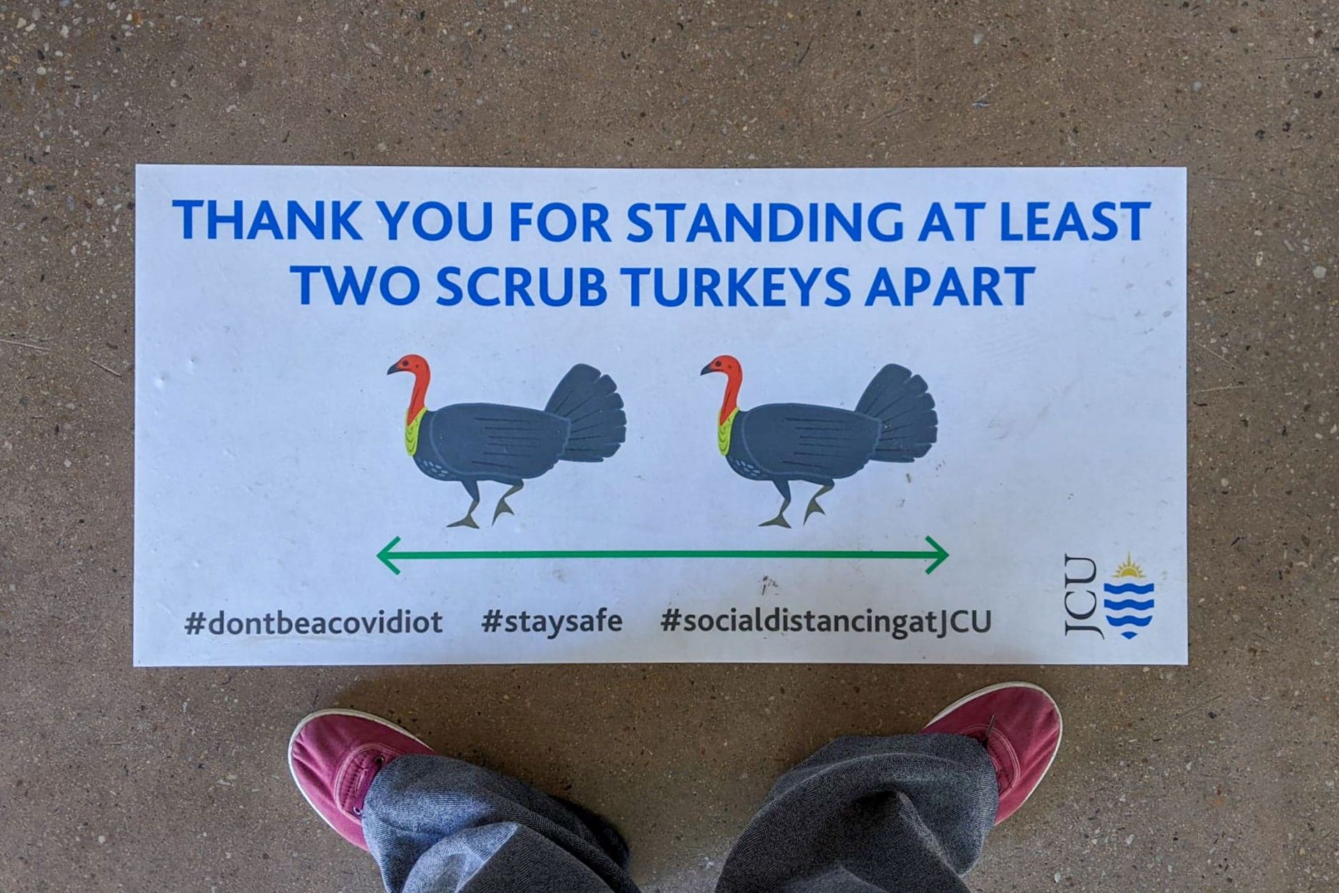 Looking down at a sign on the ground saying 