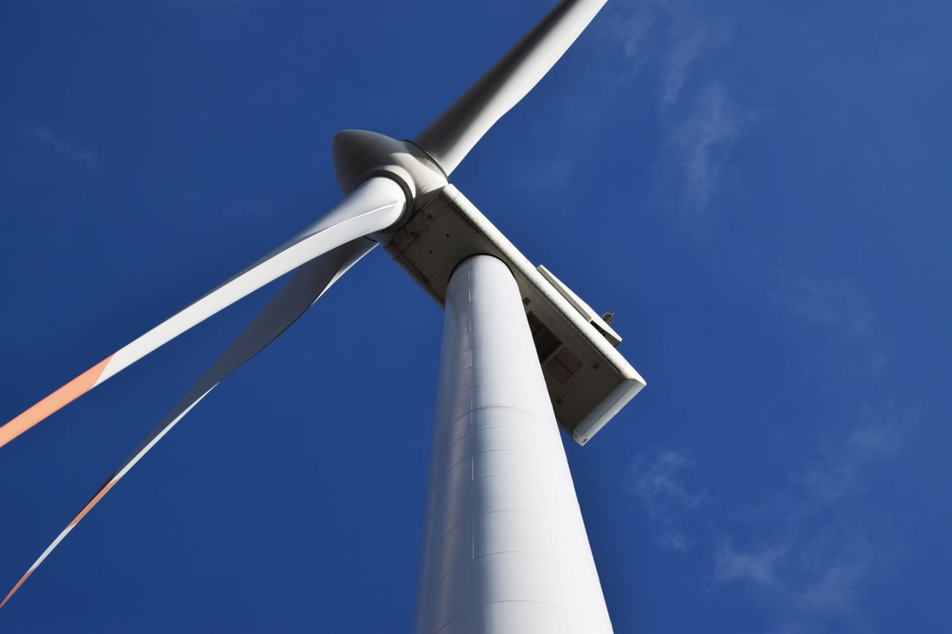 Looking up at a wind turbine