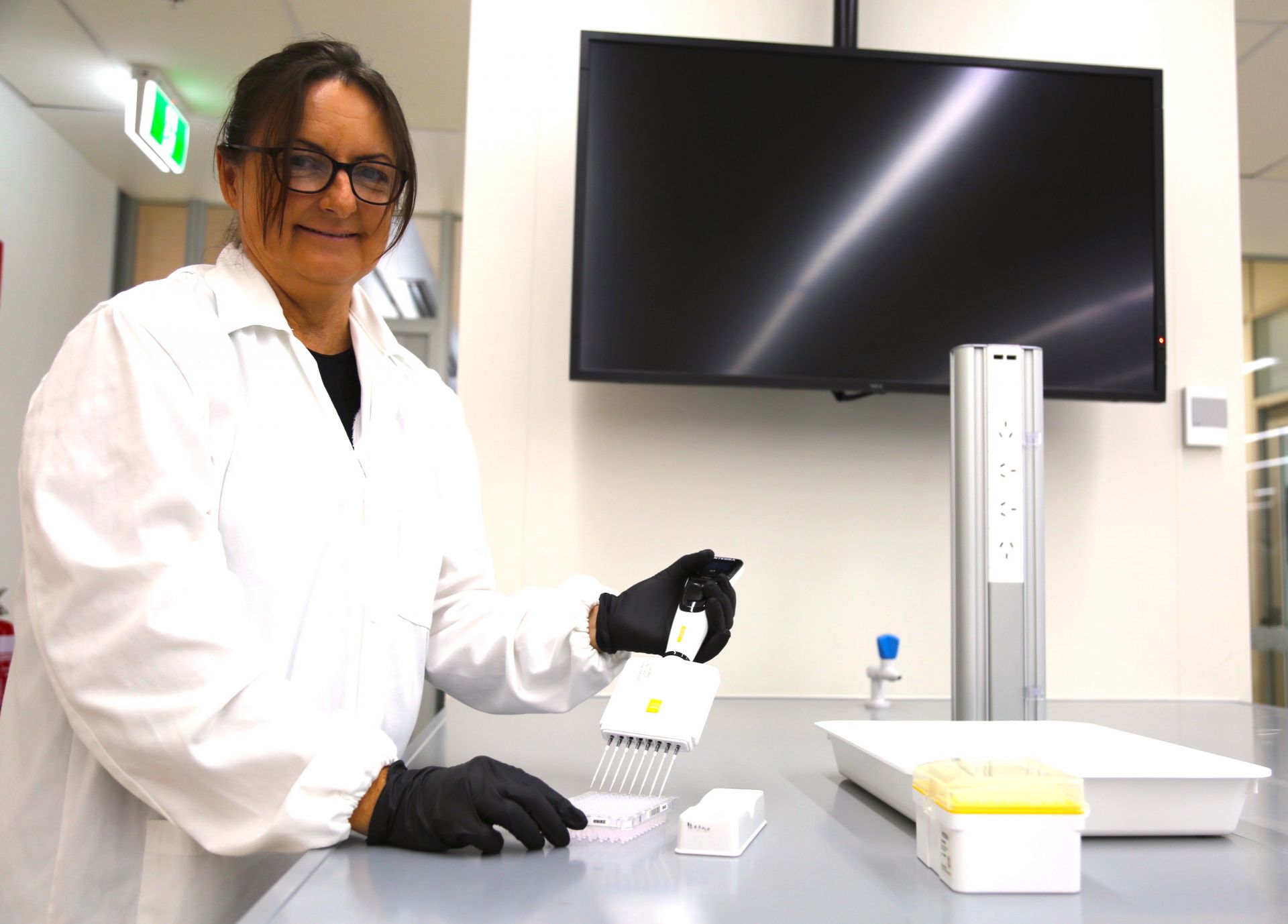 Lead JCU researcher Dr Kelly Condon pipetting liquid