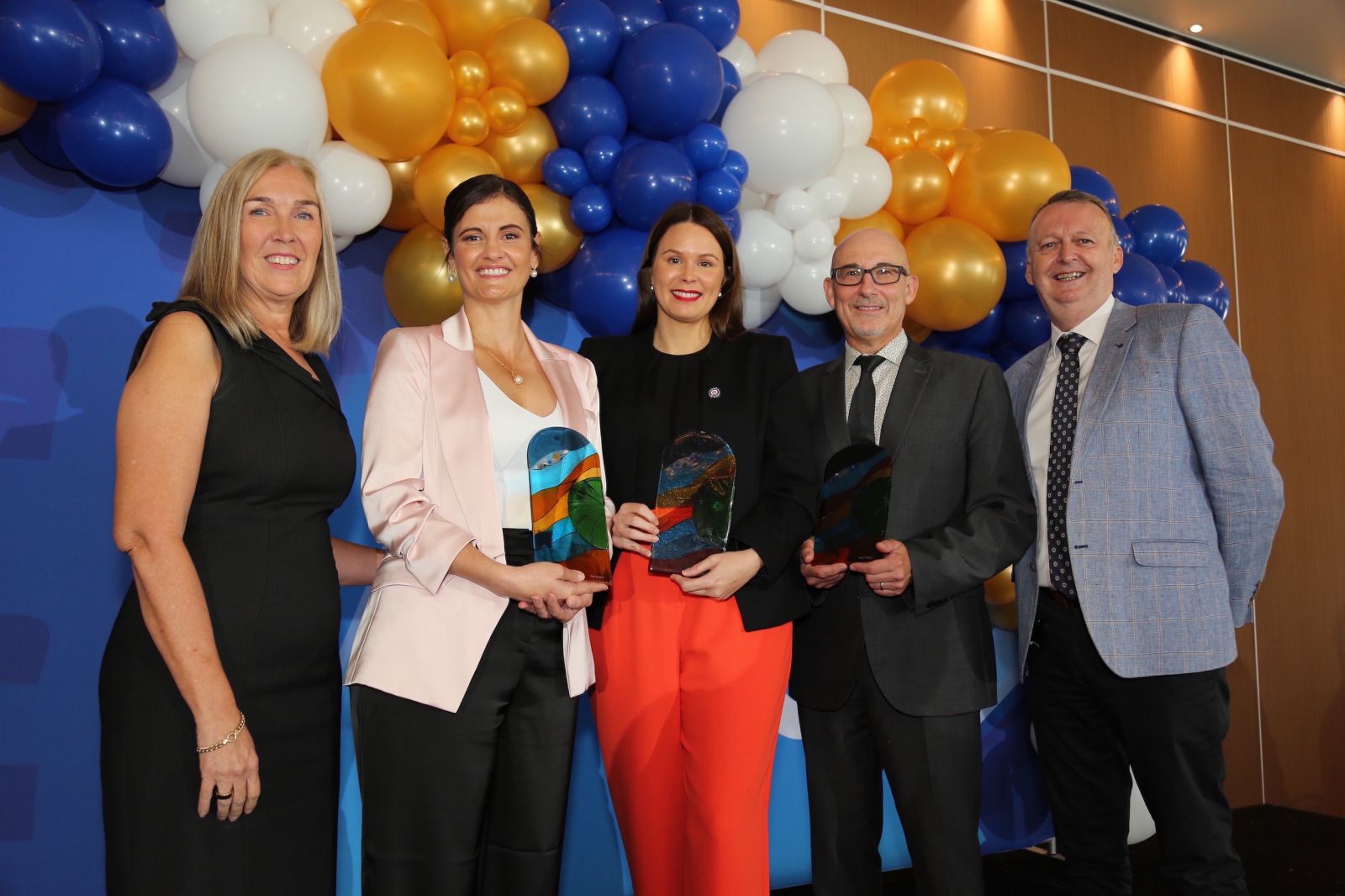 JCU Deputy Chancellor Jayne Arlett, Rising Star Award recipient Lydia Gentle OAM, Outstanding Indigenous Alumni Award recipient Melia Benn, Chancellor's Distinguished Award recipient Dr William Lyons and JCU Vice Chancellor Professor Simon Biggs at the JCU Outstanding Alumni Awards.