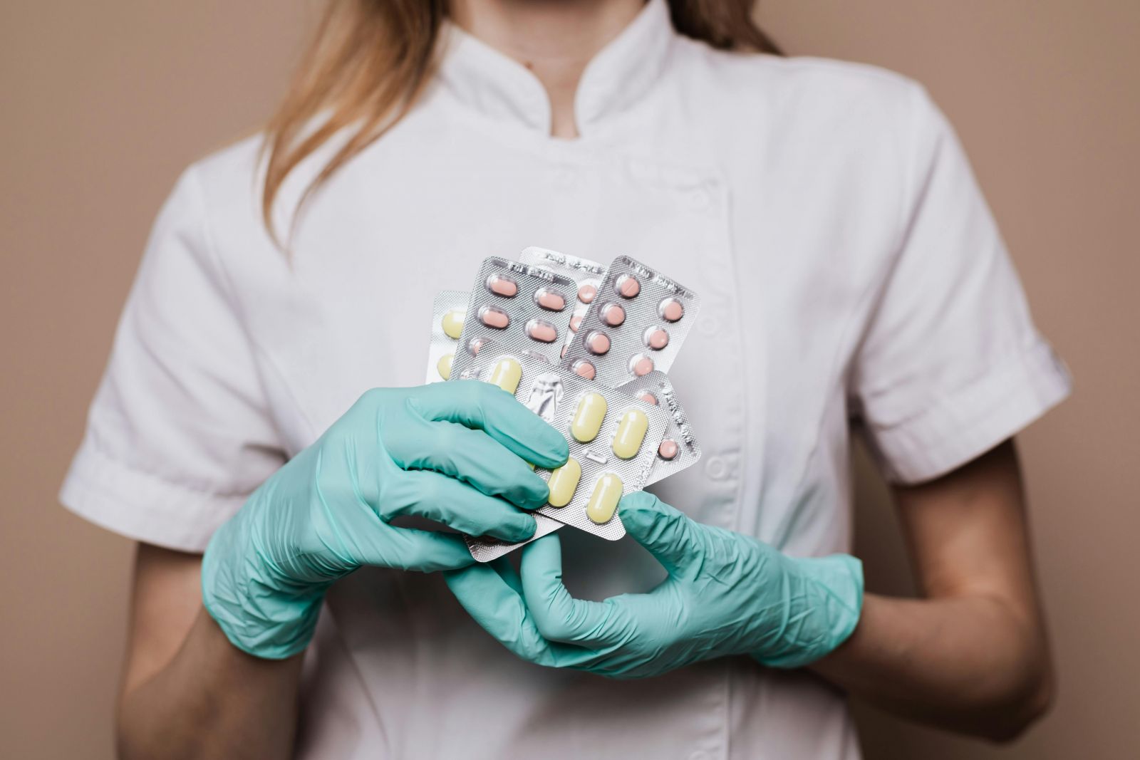 A photo of a pharmacist holding up medication.