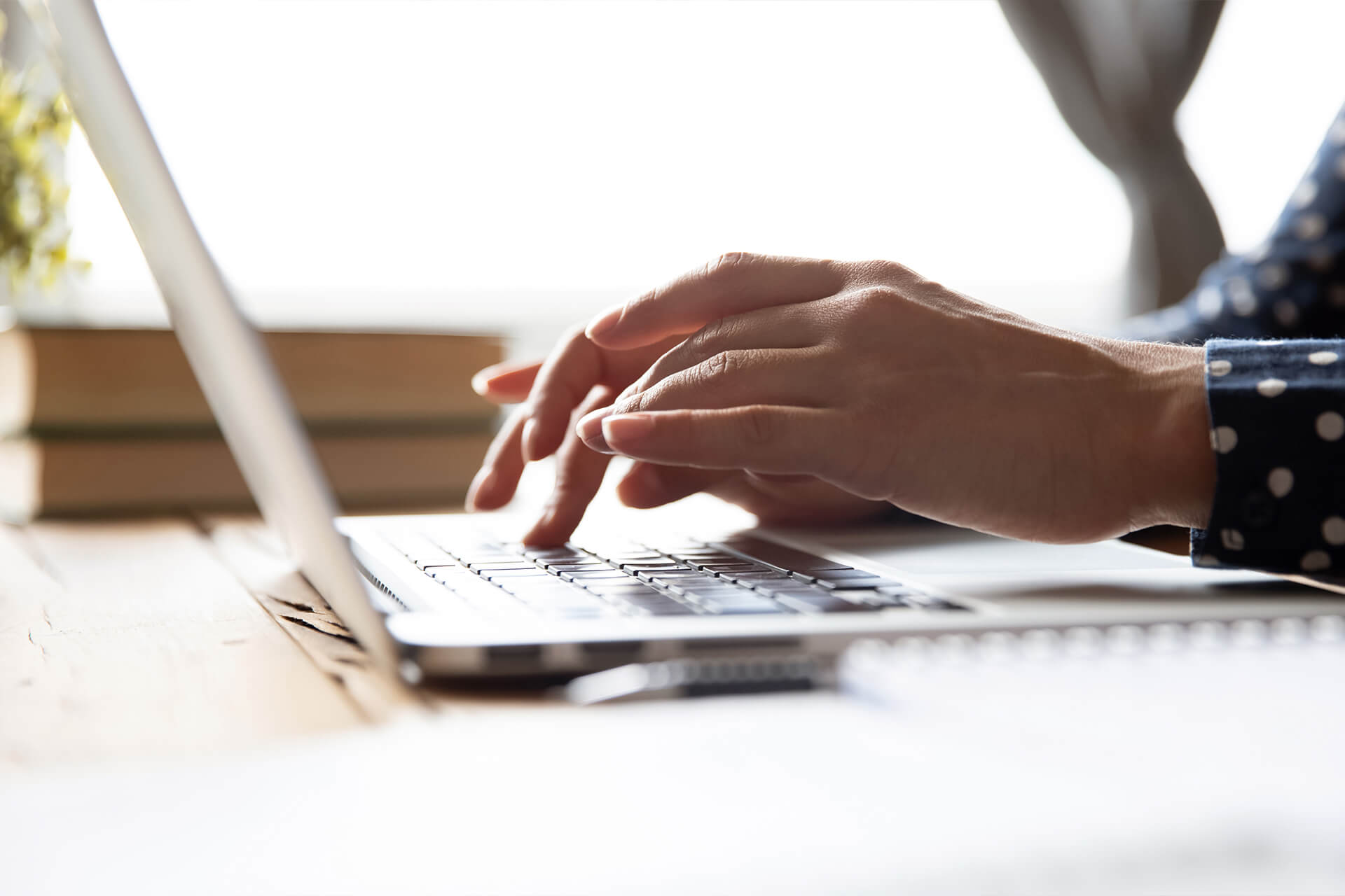 Hands typing at a keyboard. 