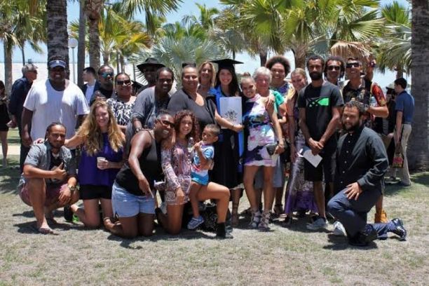 large family group with uni graduate in cap and gown