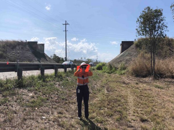 Lara Mullamphy standing on side of road in hi vis clothing with thumbs up