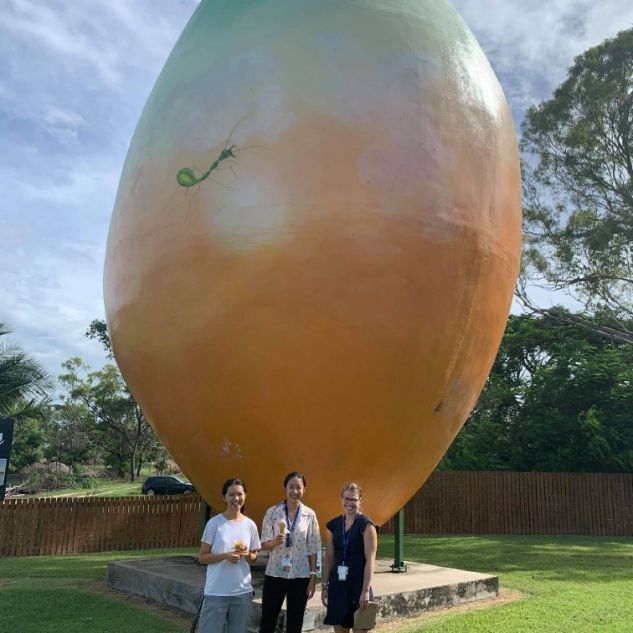 Lara Emmett and two friends standing in front of Big Mango in Bowen