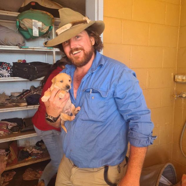 Dr Campbell Costello holding a puppy. 
