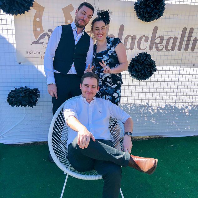 Three people dressed up in racewear