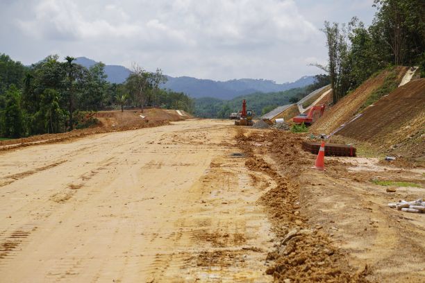 A construction site on a patch of dirt and cleared land in the middle of a rainforest in Malaysia. 