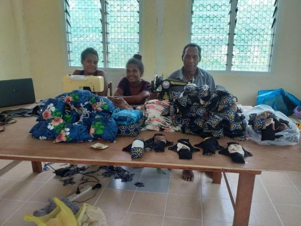 Dorothy's team with the hygienic pads they sewed