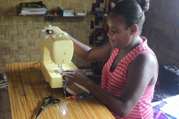 A woman on Dorothy's team sewing a hygienic pad