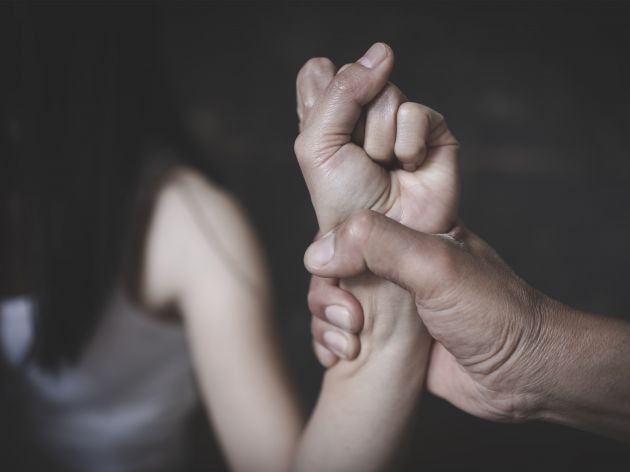 An image of a woman's wrist grabbed. 