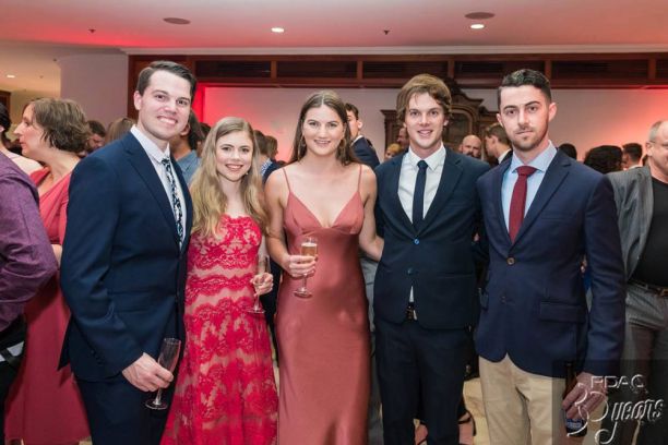Three men and two women in formal wear