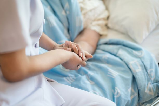 Nurse holding a hand