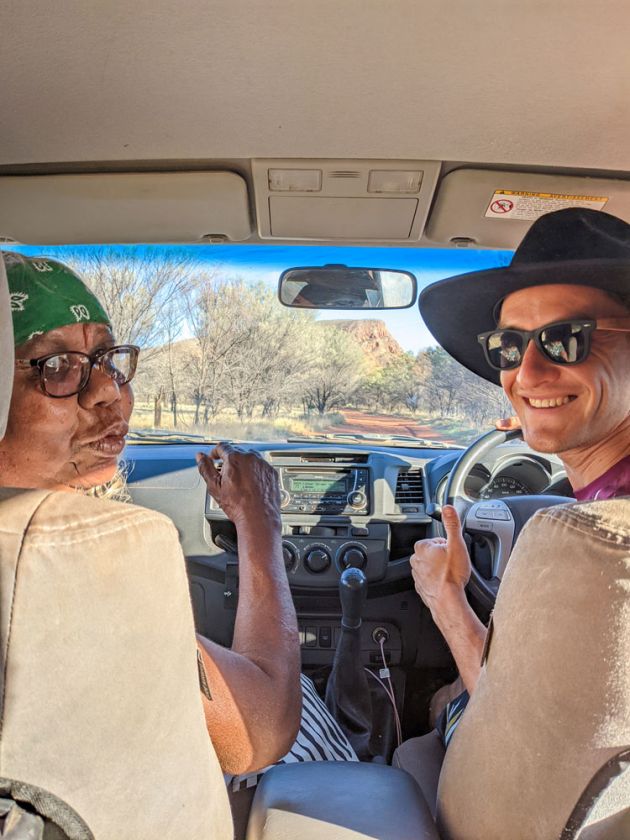 man in black hat and Aboriginal woman at waterhole