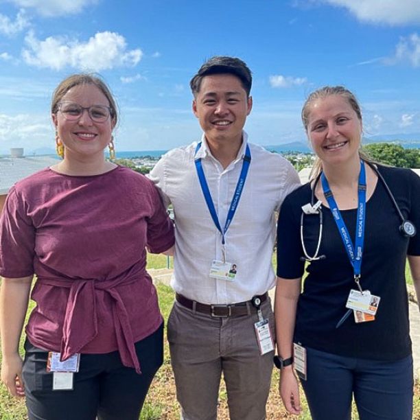Three student doctors wearing lanyards