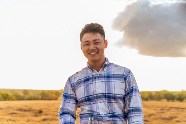 Man in checked shirt in bush setting