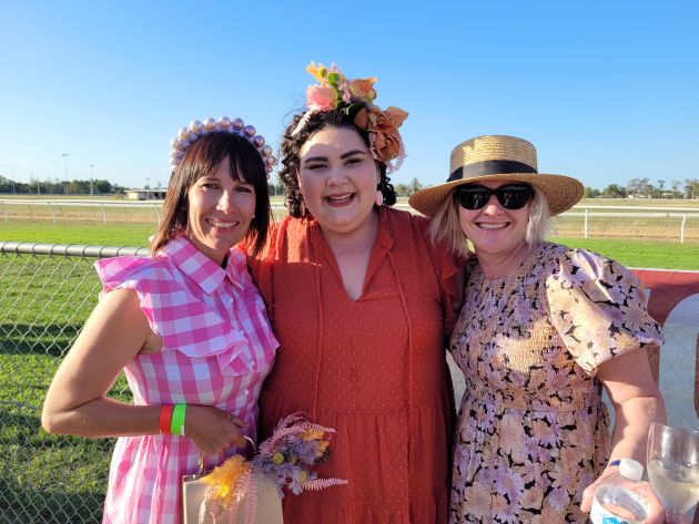 Lauren Krause with two friends outside at the races. 