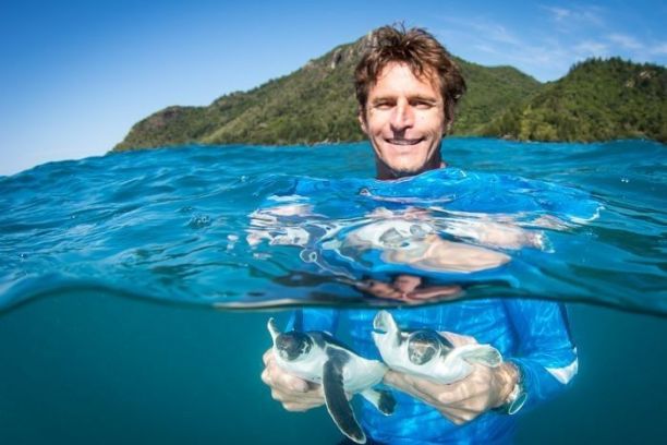 Professor Mark Hamann with baby turtles