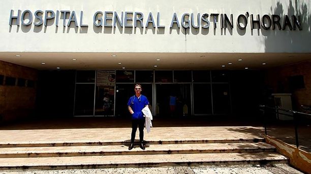 Man standing in front of a hospital
