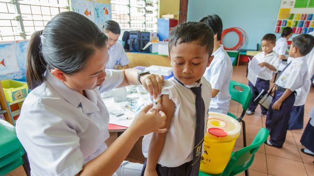 Nurse administers TB vaccines to schoolchildren 