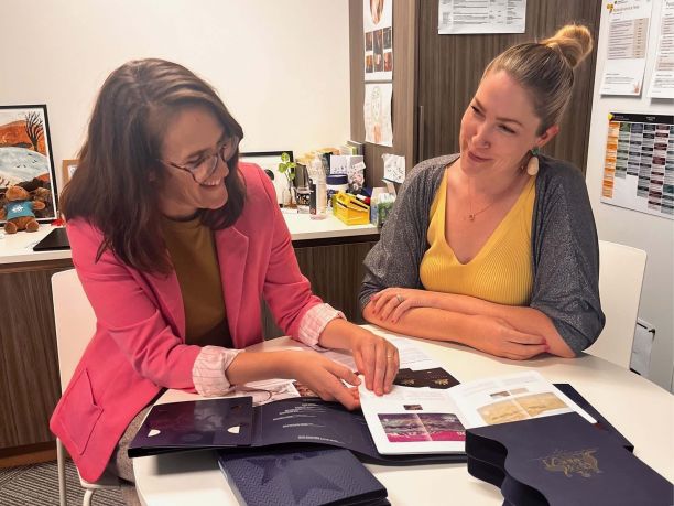 Tori Lamb sits with a female co-worker in her office. 