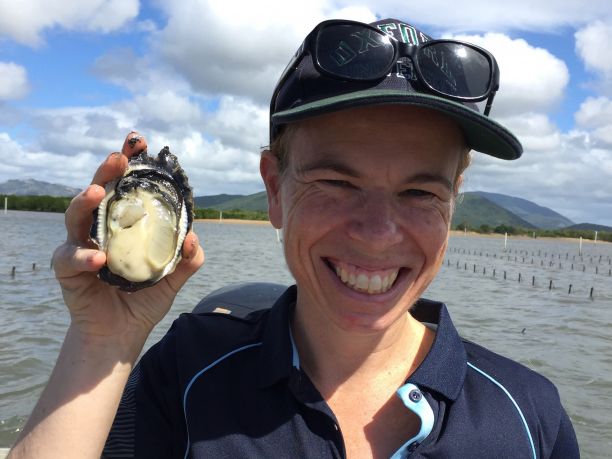 JCU Professor Jan Strugnell holds an oyster. 