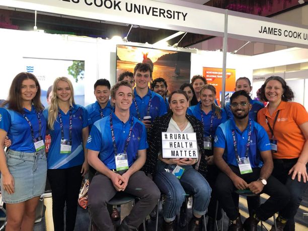 Group at JCU stall with #RURALHEALTHMATTER sign