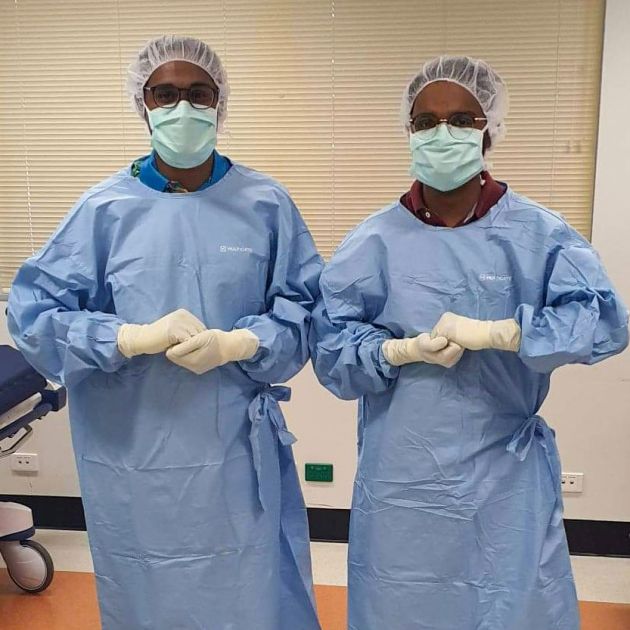 two men in surgical scrubs